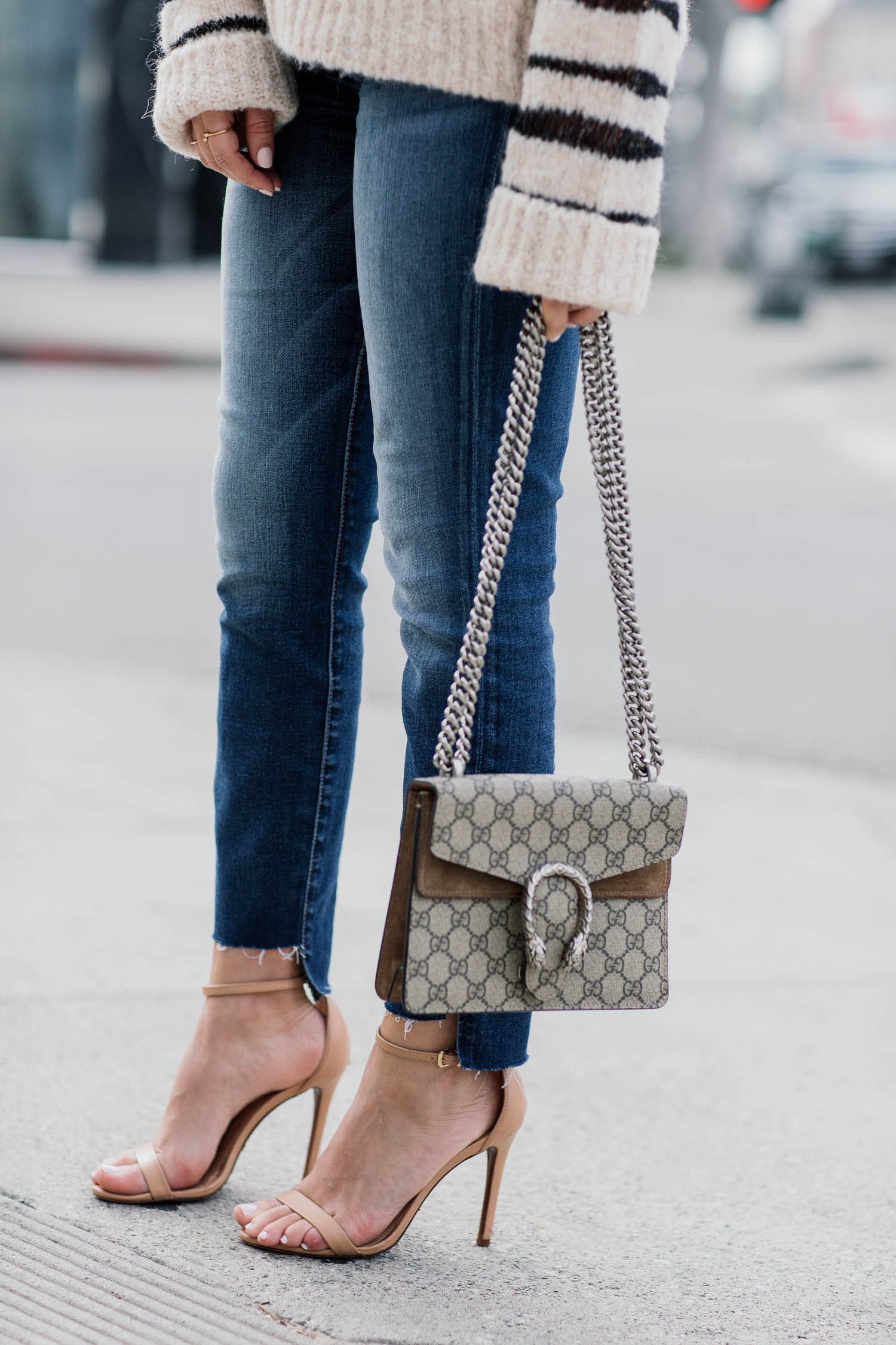 Blogger Sara Azani of Style MBA wearing Zadig and Voltaire white and black knit sweater, 7 For All Mankind crop skinny jeans, Steve Madden Stecy nude high-heeled sandal, Le Specs sunglasses, and a Gucci bag.